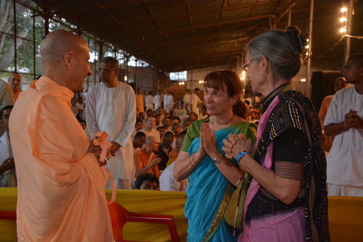 Radhanath Swami talking with senior devotees.